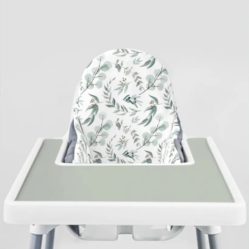 IKEA ANTILOP highchair fitted with a eucalyptus print cushion cover and a sage silicone placemat on the tray