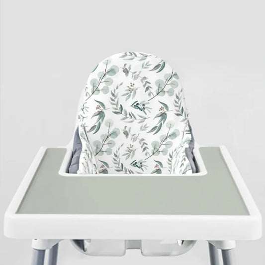 IKEA ANTILOP highchair fitted with a eucalyptus print cushion cover and a sage silicone placemat on the tray